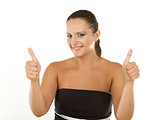Attractive young brunette businesswoman shows the sign thumbs up