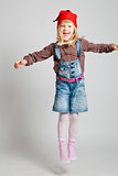 Smiling girl wearing Christmas hat and jumping