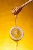 Close-up shot of honey flowing on lemon 