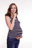 Pregnant woman with finger before the lips