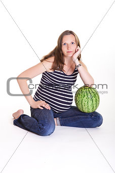 Pregnant woman with big green watermelon
