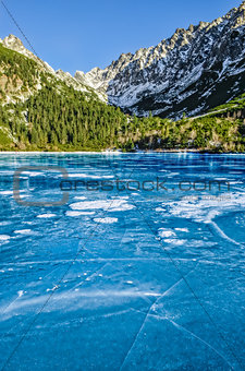 Mountain ice lake with cracked textured ice