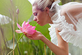 happy bride smelling a lotus