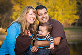 Happy Mixed Race Ethnic Family Playing In The Park