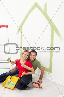 Happy couple painting in their home