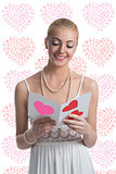 blonde girl takes a valentine postcard