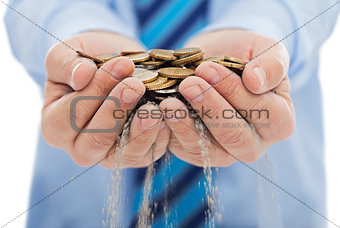 Businessman holding sand and coin