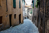 Narrow Alley With Old Buildings In Medieval Town of Siena, Tuscany