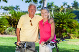 Happy Senior Couple on Bicycles In Park