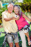 Senior Couple Bicycles Taking Digital Camera Picture
