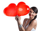 sexy brunette with heart shaped balloons smiles