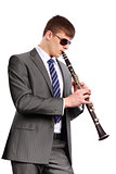 Young musician with sunglasses playing the clarinet  