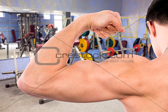 Flexing biceps in gym