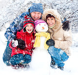 Happy family with snowman