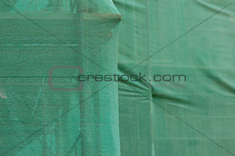 scaffold under debris netting at construction site
