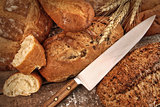 A selection of bread loaves with knife