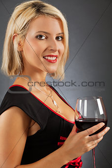 Attractive blond drinking red wine