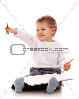 Boy drawing with a pencil
