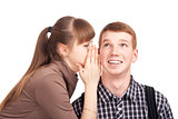 Young woman telling a secret to a man