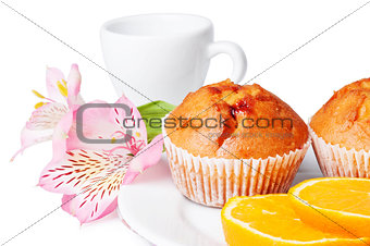 Two muffins, orange and flowers