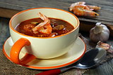 Tomato soup with mussels and shrimp.