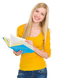 Portrait of smiling student girl with book