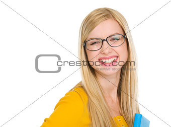 Portrait of smiling student girl in glasses with book