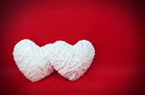 Two white hearts made from wool 