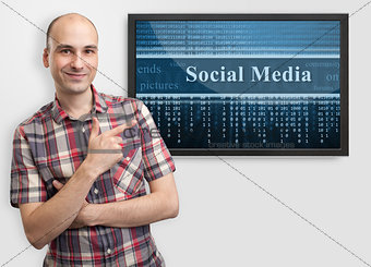 man pointing finger on screen with social media content