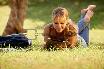 Woman with books and ipad studying for college test