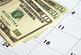 Money on a calendar concepts of financial planning