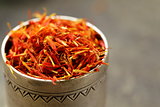Saffron spice in metal bowl macro shot soft focus