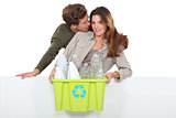 Man and woman with garbage for recycling