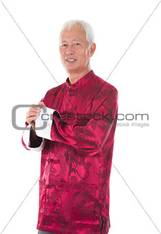 asian  senior chinese man celebrating lunar new year, with tradi