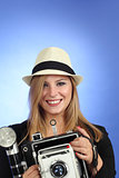 Blond woman pointing an old camera