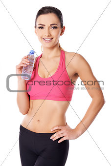Beautiful female athlete drinking water