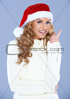 Portrait of an attractive woman wearing a red Santa hat