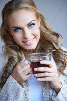 Closeup portrait of a pretty woman holding a cup of tea