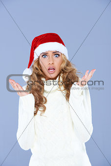 Sexy woman in Santa hat with hands raised