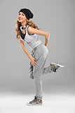 Female modern dancer posing on grey