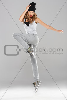 Female modern dancer posing on grey