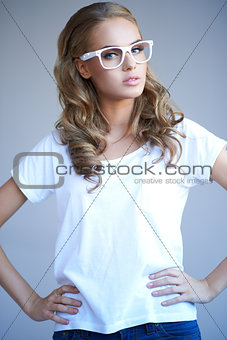 Portrait of a lovely young girl wearing stylish white glasses