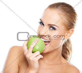 Beautiful  young woman bites a green apple