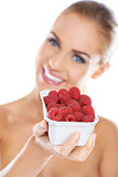 Close up of smiling blonde holding raspberries