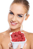 Close up of smiling blonde holding raspberries