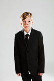 Serious young boy wearing black suit