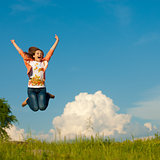 Young pretty woman jumping against blue sky