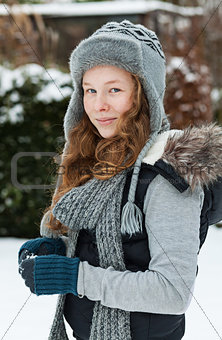 Teenager girl holding snowball