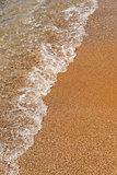 sea caresses the sand on the beach