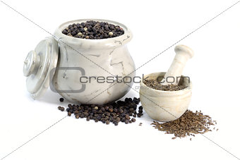 Pepper and Cumin in little bowls on on white background